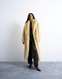 Model wearing Faux fur super long oversized shawl coat in buttermilk