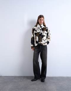 Model wearing Faux fur western trucker jacket in cow print
