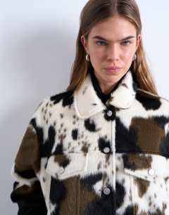 Model wearing Faux fur western trucker jacket in cow print