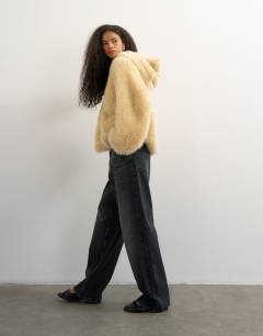 Model wearing Faux fur zip through hooded jacket in cream