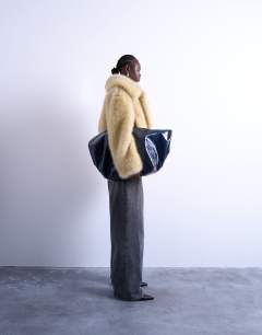 Model wearing Faux fur zip thru bomber jacket in buttermilk