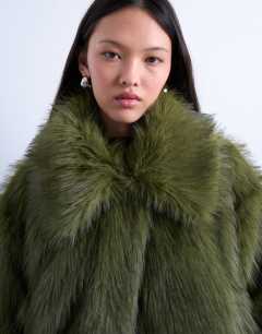 Model wearing Faux fur zip thru bomber jacket in olive