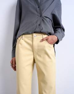 Model wearing Faux leather ankle grazer trouser in buttermilk