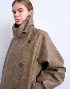 Model wearing Faux leather asymmetric oversized bomber with funnel neck in washed brown 
