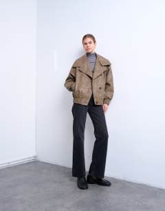 Model wearing Faux leather asymmetric oversized bomber with funnel neck in washed brown 