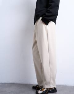 Model wearing Faux leather awk length pull on trouser in ecru