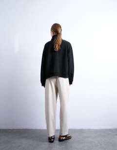 Model wearing Faux leather awk length pull on trouser in ecru