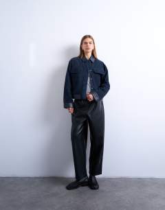 Model wearing Faux leather awkward length pull on trouser in black
