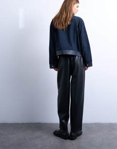 Model wearing Faux leather awkward length pull on trouser in black