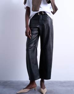 Model wearing Faux leather barrel leg trouser in black