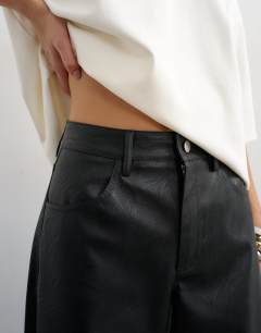 Model wearing Faux leather barrel leg trouser in black