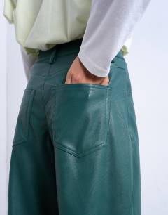 Model wearing Faux leather barrel leg trouser in teal
