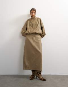 Model wearing Faux leather barrel midi skirt in taupe