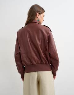 Model wearing Faux leather bomber jacket in burgundy