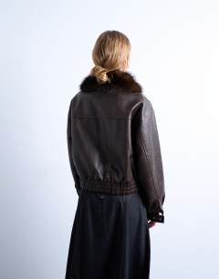 Model wearing Faux leather boxy zip through pocket bomber jacket with detachable fur collar in washed brown