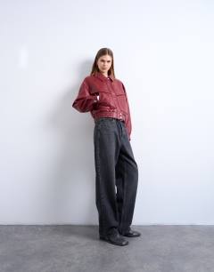 Model wearing Faux leather bubble boxy zip through pocket bomber jacket in red