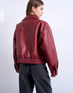 Model wearing Faux leather bubble boxy zip through pocket bomber jacket in red