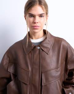 Model wearing Faux leather bubble boxy zip through pocket bomber jacket in washed brown