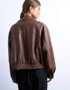 Model wearing Faux leather bubble boxy zip through pocket bomber jacket in washed brown