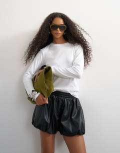 Model wearing Faux leather bubble short in black