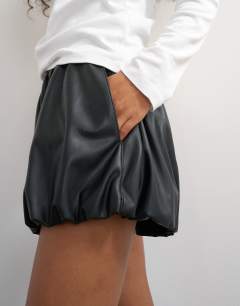 Model wearing Faux leather bubble short in black