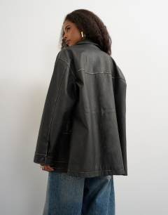 Model wearing Faux leather cinch waist jacket in black