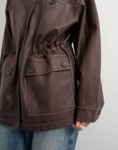 Model wearing Faux leather cinched jacket in washed brown