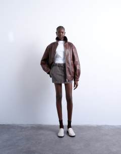 Model wearing Faux leather contrast heavy wash bomber jacket in brown