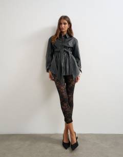 Model wearing Faux leather contrast stitch belted shirt in black