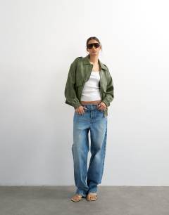 Model wearing Faux leather cropped bomber jacket with patch pocket in washed green