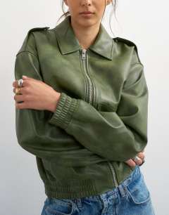 Model wearing Faux leather cropped bomber jacket with patch pocket in washed green