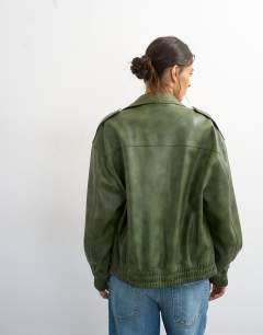 Model wearing Faux leather cropped bomber jacket with patch pocket in washed green