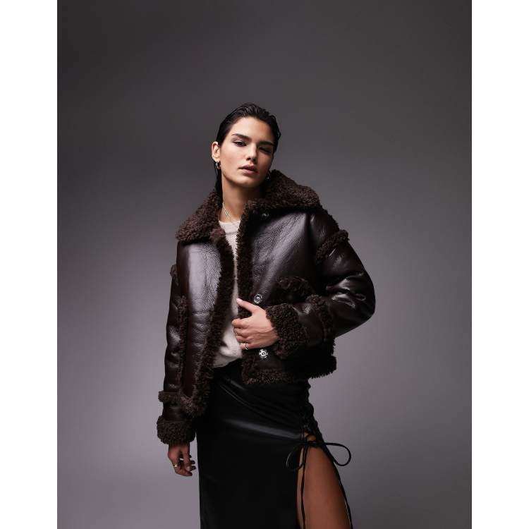 Topshop chocolate brown faux leather cropped car coat with faux fur trims and a spread collar. It has a cropped fit, press-stud placket and side pockets. 