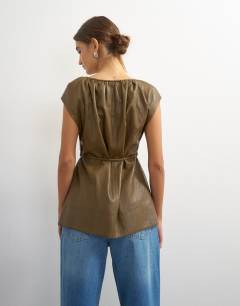 Model wearing Faux leather deep neckline tie detail top in olive