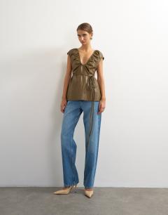 Model wearing Faux leather deep neckline tie detail top in olive