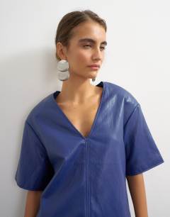 Model wearing Faux leather deep V neckline top in navy