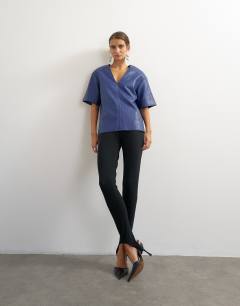 Model wearing Faux leather deep V neckline top in navy