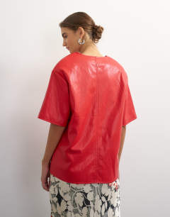 Model wearing Faux leather deep V neckline top in red