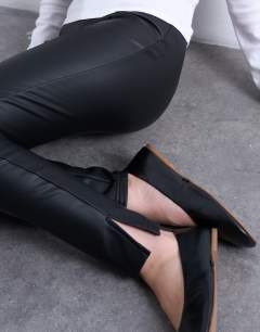 Model wearing Faux leather drain pipe skinny trouser in black
