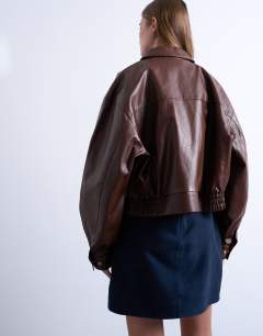 Model wearing Faux leather drop shoulder cropped zip thru jacket in chocolate