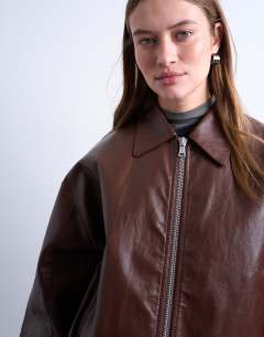 Model wearing Faux leather drop shoulder cropped zip thru jacket in chocolate