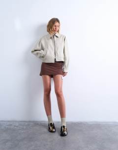 Model wearing Faux leather drop shoulder cropped zip thru jacket in ecru