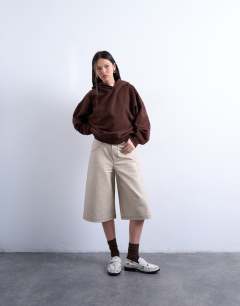 Model wearing Faux leather editor longline short in cream