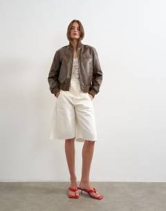 Model wearing Faux leather fitted bomber jacket in washed brown