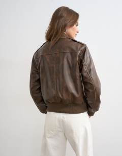 Model wearing Faux leather fitted bomber jacket in washed brown