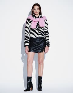 Model wearing Faux leather frogging detail mini skirt in black