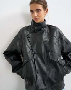Model wearing Faux leather funnel button through jacket in black