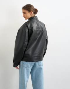 Model wearing Faux leather funnel button through jacket in black