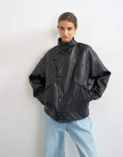 Model wearing Faux leather funnel button through jacket in black