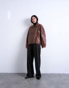 Model wearing Faux leather funnel neck biker jacket in washed brown
